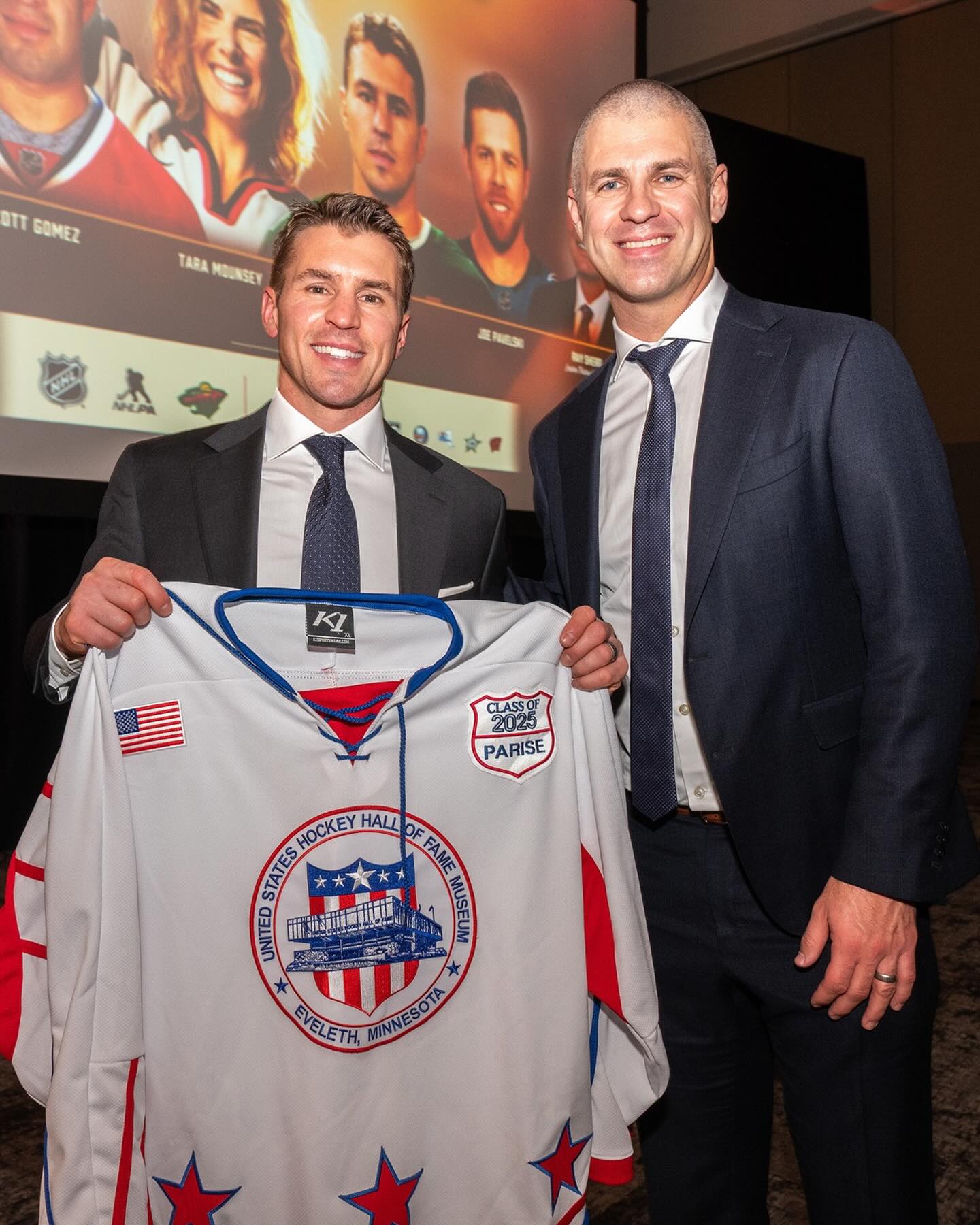 Two Hall of Fame guys: Zach Parise (left) holds up a jersey given to him upon his induction into the US Hockey Hall of Fame on Dec. 10, 2025. Next to him is former Minnesota Twins player Joe Mauer, a first ballot Baseball Hall of Fame inductee in 2024.#usahockey #mauer #minnesotawild #minnesotatwins #halloffame