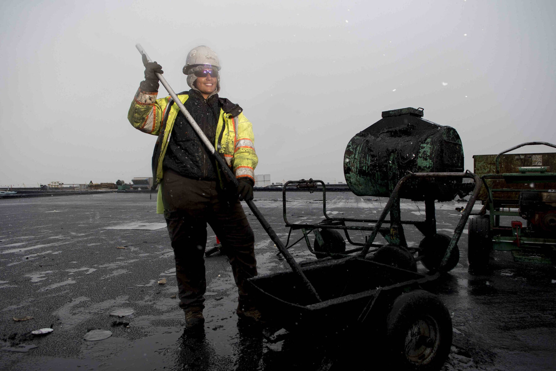 Black female union roofer during winter construction