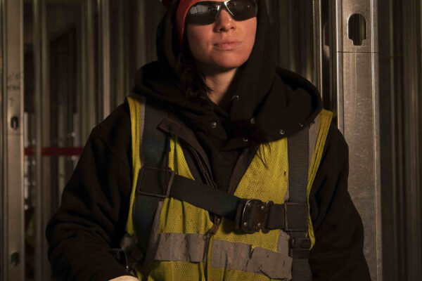 female iron worker constructing high rise