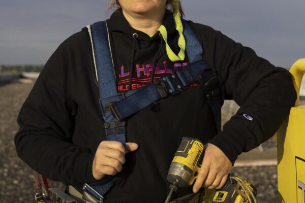 Female union painter holding DeWalt drill