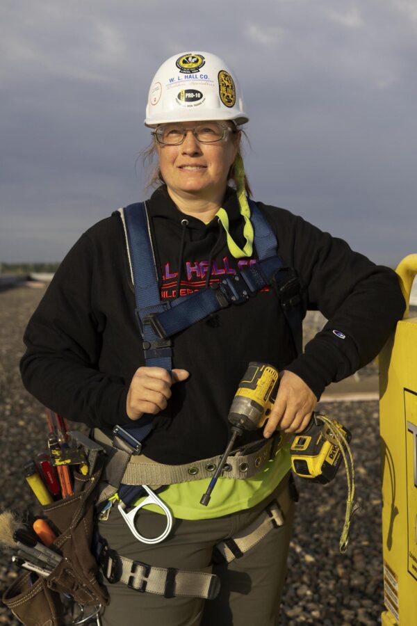 Female union painter holding DeWalt drill