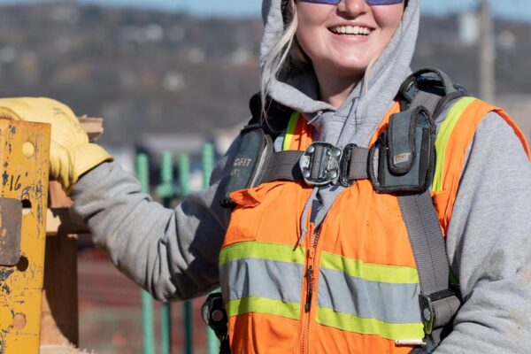 Female Woman union carpenter working on a bridge