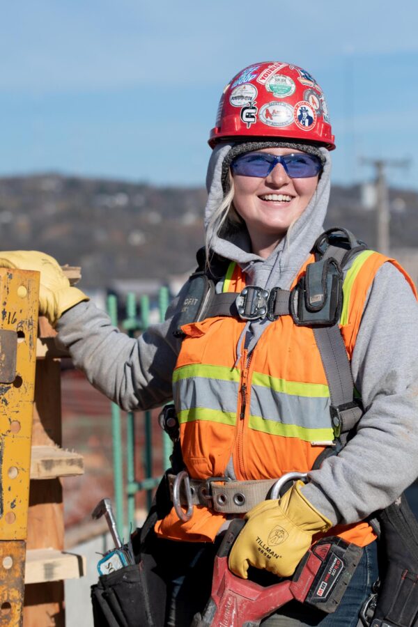 Female Woman union carpenter working on a bridge