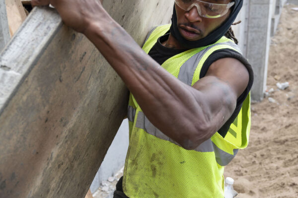 Laborers union worker carrying wood